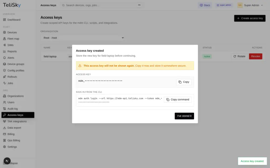The one-time access key reveal with a copy button and a ready-to-paste mdm auth login command.